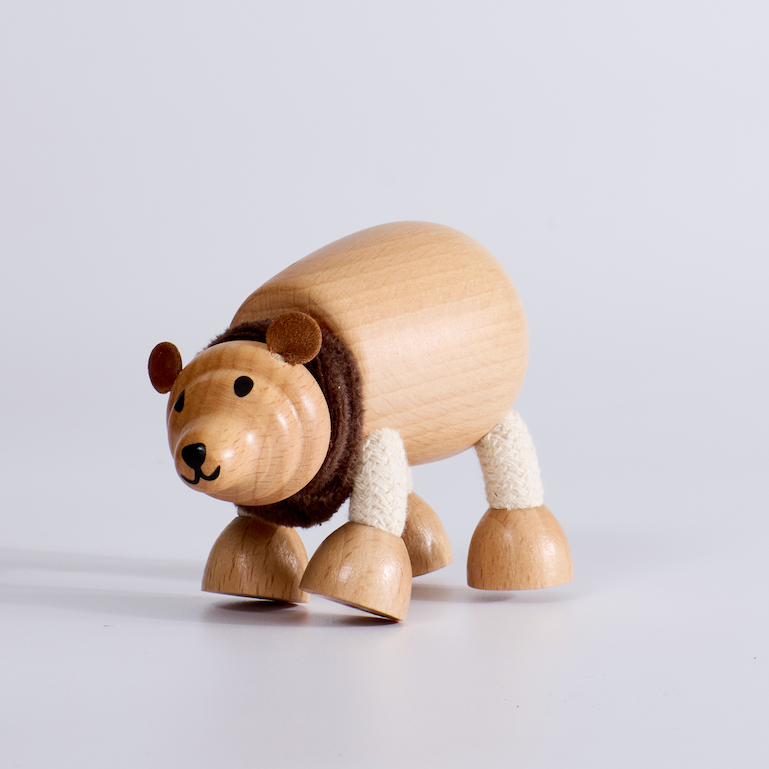 Wooden toy bear on a light gray background