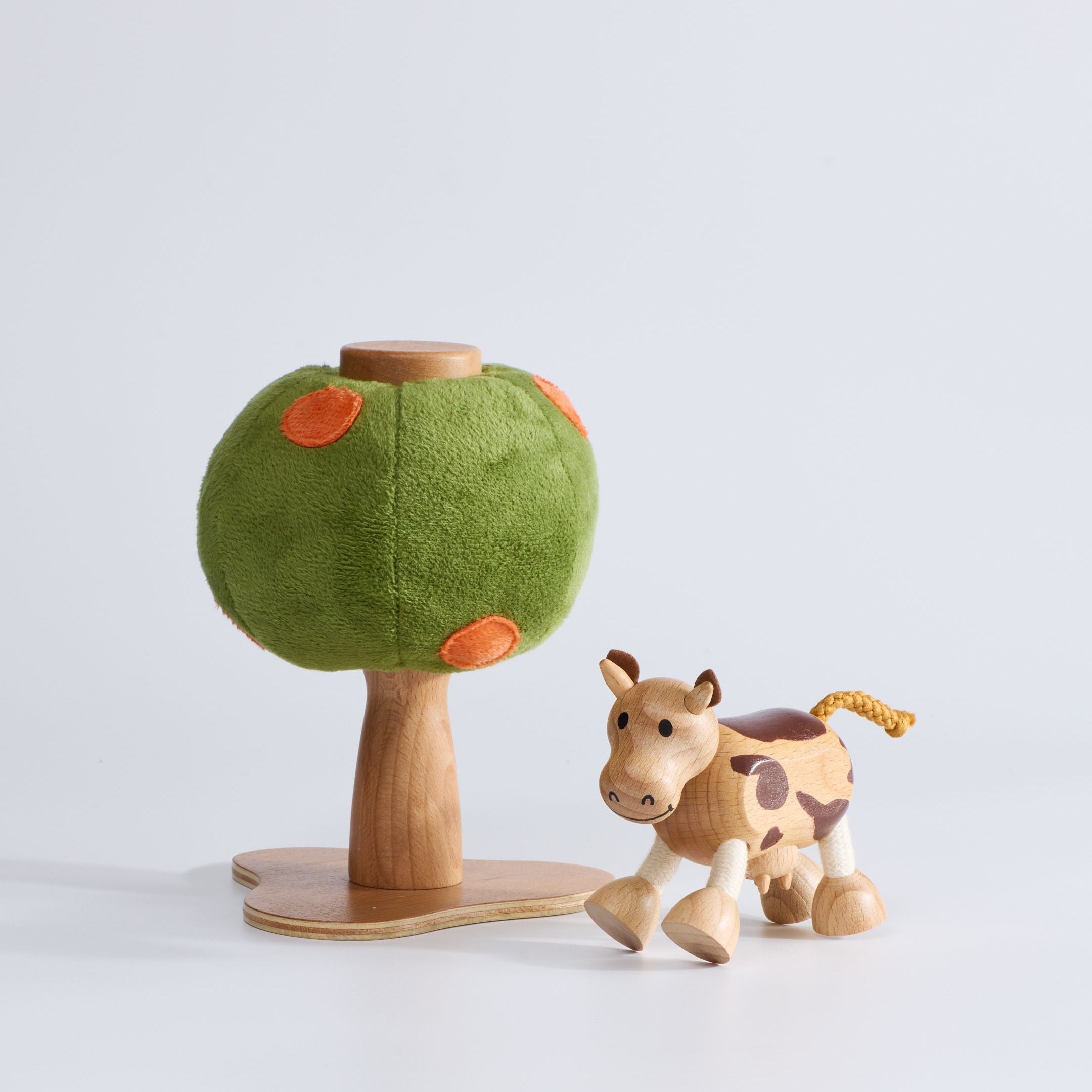 Anamalz Orange Tree toy with a green plush canopy, orange spots, and a wooden trunk and base and a wooden toy cow in front of it