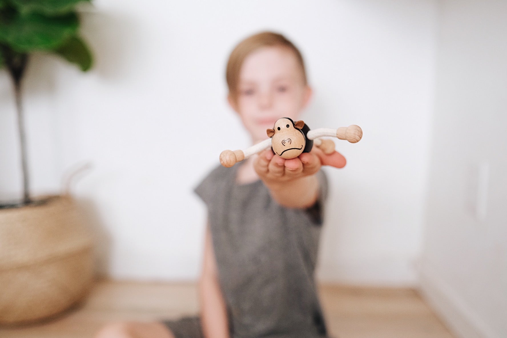 Eco-friendly wooden gorilla toy with flexible arms, perfect for imaginative play and learning.