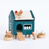 Toy chicken coop with chickens and eggs on a white background