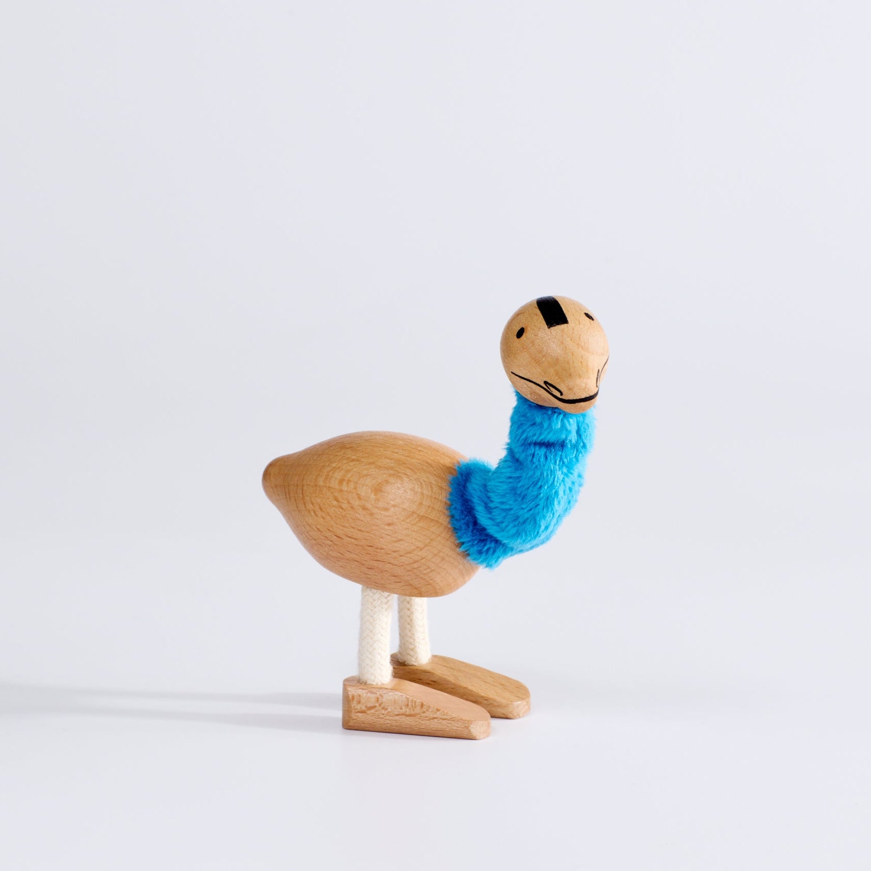 A handcrafted wooden toy emu with a soft scarf, displayed against a white background.